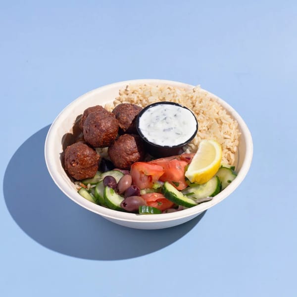 Efi's Gyro bowl with meatballs, rice, cucumber, tomatoes, olives, lemon, and tzatziki sauce.